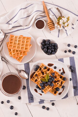 Waffles with blueberries and chocolate cream.