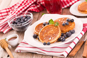 Pancakes with blueberries and chocolate cream.