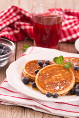 Pancakes with blueberries and chocolate cream.