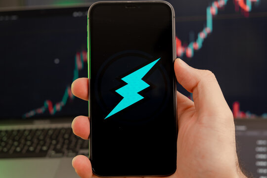 Electroneum ETN app of cryptocurrency stock market analysis on the screen of mobile phone in man hands and growing charts trading data on the background, February 2022, San Francisco, USA. 
