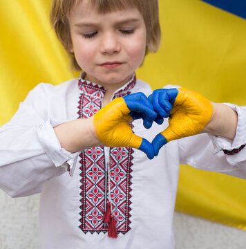 children's hands are painted in the colors of the Ukrainian flag in the shape of a heart. national independence, patriotism. children against war. Hands off Ukraine