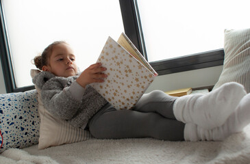 CHILD READING A STORY