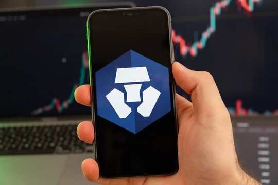 Crypto.com Coin CRO app of cryptocurrency stock market analysis on the screen of mobile phone in man hands and growing charts trading data on the background, February 2022, San Francisco, USA. 