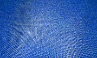 close up blue textile mesh background with blank space for design. abstract blue foil metallic background with light reflections. shiny textured wall. macro drapery luxury blue texture.