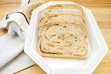 Rye & Pumpernickel Swirled Loaf of Bread on a White Platter