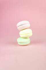 Multi Colored Stacked Up French marshmallows looks like Macarons on Pink, Colorful French macarons background.