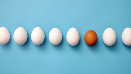 A group of white eggs and one brown one among them. A symbol of unusual people in society