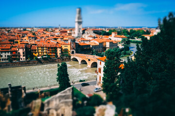 Miniature of Verona old town cityscape with Ponte Pietra roman arch bridge and Adige river with clear blue sky during summer time