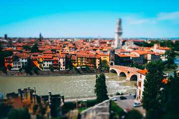 Miniature of Verona old town cityscape with Ponte Pietra roman arch bridge and Adige river with clear blue sky during summer time