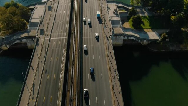 Aerial drone reveal shot of Paris La Defense business district skyline, the Neuilly bridge and Seine river on a beautiful sunny day, Paris France 