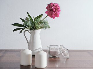  lifestyle interior decoration pink peony flower with candles on rustic wooden table. cozy home...
