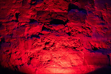 Mystical illumination of the brick wall in the old basement of the castle. Mysterious horror atmosphere