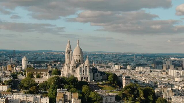Establishing aerial view of Paris Sacre-Coeur and Montmartre hill on a beautiful day, Paris France gothic architecture 