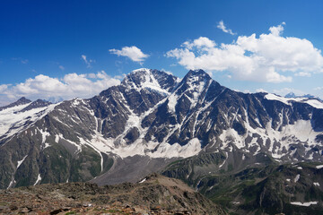 Steep slopes of the Altai Mountains covered with eternal snow