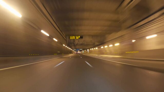 Point of view hyper-lapse time-lapse from a car driving in a tunnel and Paris streets at night, Paris Skyline view 