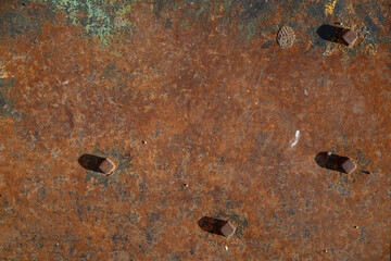 vintage rusty metal sheet with bolts and rivets. The sheets became irregularly shaped fastened...