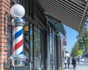 Los Angeles, CA, USA - February 25, 2022: Close up of a traditional Barber’s Pole in front of a...