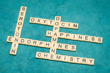 dopamine, oxytocin, serotonin and endorphins, happiness brain chemicals, chemistry and physiology concept, crossword in ivory tiles against textured handmade paper - obrazy, fototapety, plakaty
