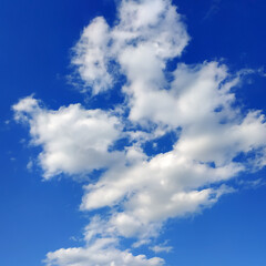 White cirrus clouds on a blue sky background