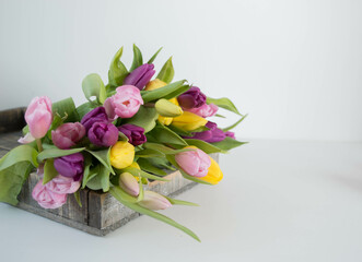 colorful tulips on a wooden tray spring