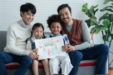 Happy Asian young LGBTQ gay couple with little cute adopted Caucasian and African kid smiling and...