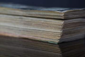 A lot of American dollars banknotes on a dark background.