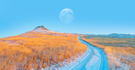 The hills with yellow grass are covered with snow Full moon in the background "Elements of this image furnished by NASA"
