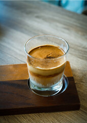 cup of coffee with milk, selective focus of strong esprresso shot.
