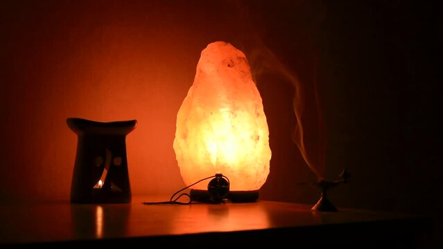 Smoke powder fires near himalayan salt and aroma lamp