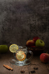 Beautiful photos of a drink made from colorful fruits and spices in a glass cup on a wooden table.
