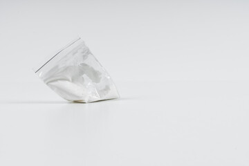 Cocaine in a plastic bag on a white background with copy space.