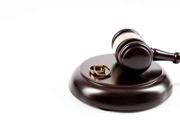 Wedding rings on the figure of a broken heart from a tree, hammer of a judge. Divorce divorce proceedings. Judge hammer wedding ring with copy space