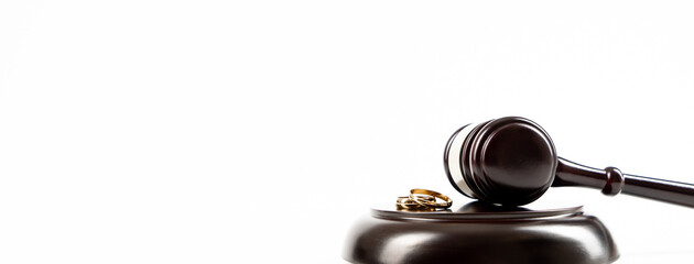 Wedding rings on the figure of a broken heart from a tree, hammer of a judge. Divorce divorce...