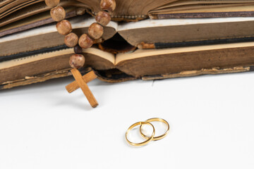 Gold wedding rings near the bible with copy space