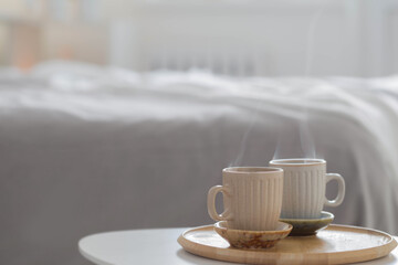 Fototapeta na wymiar two cup of coffee on wooden tray in bedroom