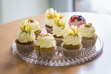 Close-up of Muffin in a basket on a glass plate placed on a table.