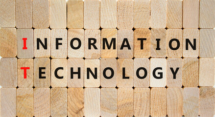 IT information technology symbol. Concept words IT information technology on wooden blocks on a beautiful wooden background. Business IT information technology concept, copy space.