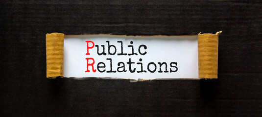 PR public relations symbol. Concept words PR public relations on white paper. Beautiful black background. Copy space. Business and PR public relations concept.
