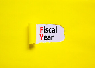 FY Fiscal year symbol. Concept words FY Fiscal year on yellow paper on a beautiful yellow table...