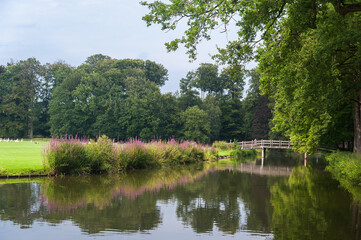 Fototapeta na wymiar City park with bridge in summer on the Schaffelaar estate in Barneveld, the Netherlands.