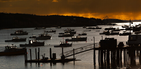 Lobster boats at anchor in Stonington Maine at sunset,