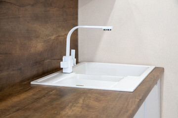 Naklejka na ściany i meble Water faucet design. Minimalism in the kitchen. Faucet in the kitchen. Water tap in the interior of the kitchen.
