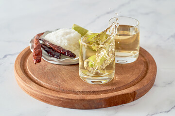 Mexican traditional tequila splash lime on a marble table