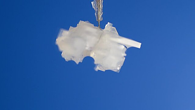 Time-lapse of the formation and growth of a crystal from a saline solution