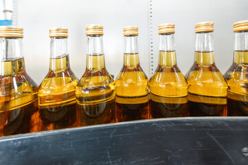 Alcohol liquor closed bottles with caps at production line