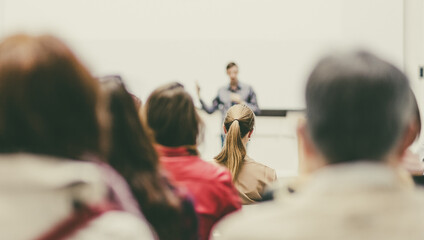 Man giving presentation in lecture hall at university.