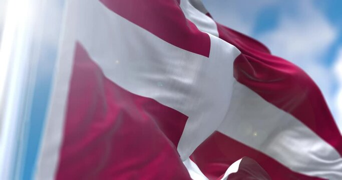 View of Danish flag flapping on flagpole with sky behind