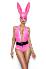 Sexy blonde woman posing in latex pink costume and pink bunny mask on white background. Easter...