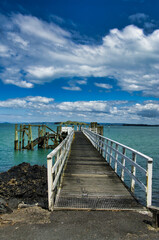 Fototapeta na wymiar The jetty of the ferry to Auckland on the volcanic Rangitoto Island in Auckland Bay. North Island, New Zealand, 