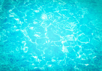 Abstract water in swimming pool. Shining sun reflection, motion of ripple wave. Background of water surface. Summer, sport, relax, vacation concept.